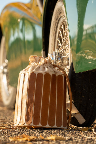 Brown leather bag with gold accents on a motorcycle
